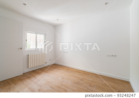 Empty room after renovation with window, white walls and wooden floor in new apartment 93248247