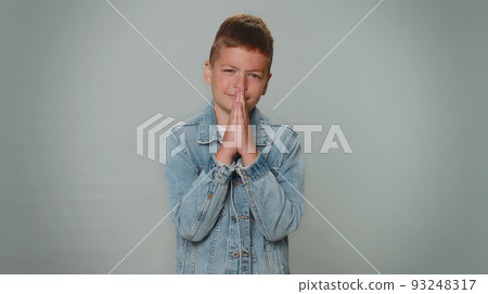 Toddler boy child kid praying, looking upward and making wish, asking for help , begging apology Toddler boy child kid praying, looking upward and making wish, asking for help , begging apology 93248317