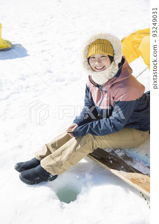 Young woman fishing for smelt Young woman fishing for smelt 93249031