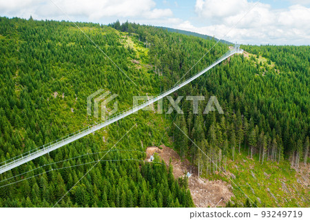Sky Bridge 721 is the longest suspension bridge between two hills in the forest, Dolni Morava, Czech Republic . One way footbridge in touristic place in the forest in summer. Sky Bridge 721 is the longest suspension bridge between two hills in the forest, Dolni Morava, Czech Republic . One way footbridge in touristic place in the forest in summer. 93249719
