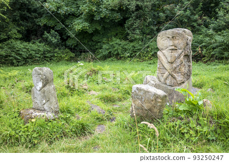 This is a bronze age stone carviing with two faces,called Janus, located In Caldragh Cemetery on Boa Island, Lower Lough Erne. Northern Ireland This is a bronze age stone carviing with two faces,called Janus, located In Caldragh Cemetery on Boa Island, Lower Lough Erne. Northern Ireland 93250247