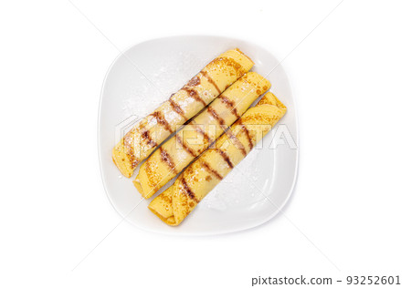 Delicious tasty homemade crepes or pancakes with forest fruit marmelade or chocolate cream on white background. Delicious tasty homemade crepes or pancakes with forest fruit marmelade or chocolate cream on white background. 93252601