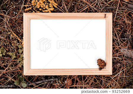Wooden frame with white blank card on green natural background in forest. Top view Flat lay Mockup 93252669