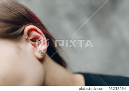 Young woman portrait piercing at beauty studio salon neon light Young woman portrait piercing at beauty studio salon neon light 93252964