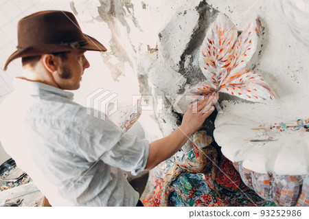 Man mosaics master in hat canadian making smalt glass mosaic panel. Male mosaicist at work Man mosaics master in hat canadian making smalt glass mosaic panel. Male mosaicist at work 93252986