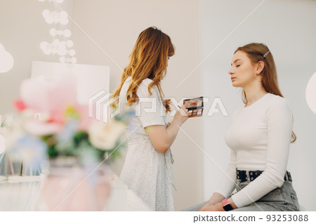 Beautiful young woman applying makeup beauty visage brush. Beautiful young woman applying makeup beauty visage brush. 93253088