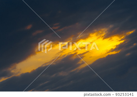Light spot orange sunset through dark rain clouds storm beam light sky weather background Light spot orange sunset through dark rain clouds storm beam light sky weather background 93253141