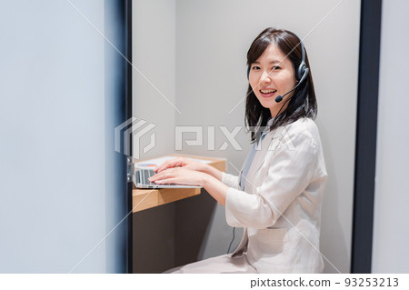 A woman having a remote meeting in a private room booth in a shared office A woman having a remote meeting in a private room booth in a shared office 93253213