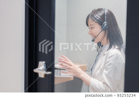 A woman having a remote meeting in a private room booth in a shared office A woman having a remote meeting in a private room booth in a shared office 93253234