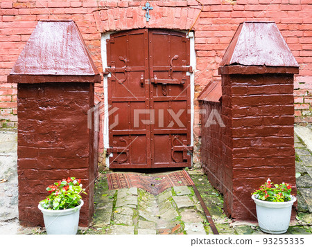 gate to basement of rural church in village 93255335