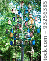 a lot of birdhouses on the pole 93256385