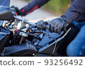 Motorcyclist holding the handlebars of a motorcycle 93256492