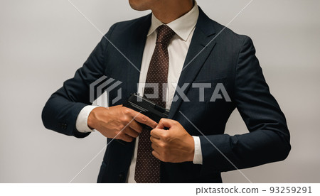 A person in a suit holding a pistol A person in a suit holding a pistol 93259291