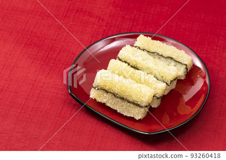 New Year's dishes 11 _ kombu kelp with red plate _ background red 93260418