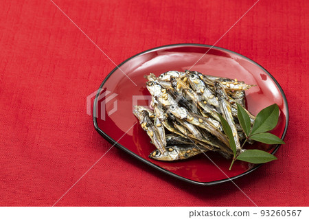 New Year dishes 12_Tazukuri in a red plate_background red New Year dishes 12_Tazukuri in a red plate_background red 93260567