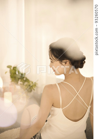 Back view of a young woman doing skin care Back view of a young woman doing skin care 93260570