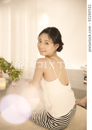 Back view of a young woman doing skin care 93260581