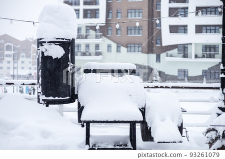 Snow covered outdoor grill. Snow-covered barbecue in an outdoor cafe 93261079