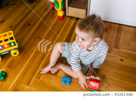 Cute little child is playing at home 93261386