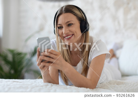 Positive blonde woman having video conference with friends Positive blonde woman having video conference with friends 93261626