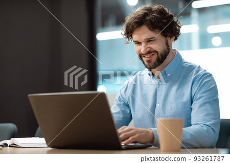 Handsome mature businessman working with laptop pc at his desk in office, blank space Handsome mature businessman working with laptop pc at his desk in office, blank space 93261787