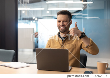 Business Man Gesturing Thumbs Up Using Laptop In Modern Office 93262194