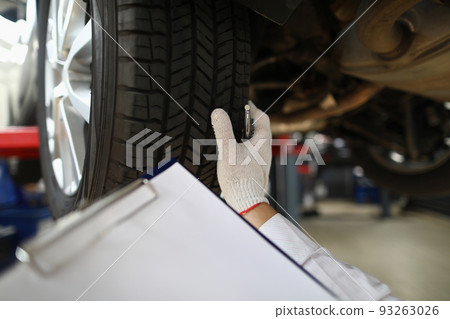 Man mechanic working under car at car service station Man mechanic working under car at car service station 93263026