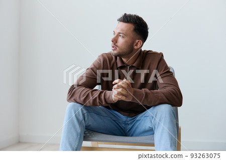 Suffering from bad relationship break up young man guy folded hands looks aside have big mental problem psychological trauma after family conflict think about life's meaning. Copy space 93263075