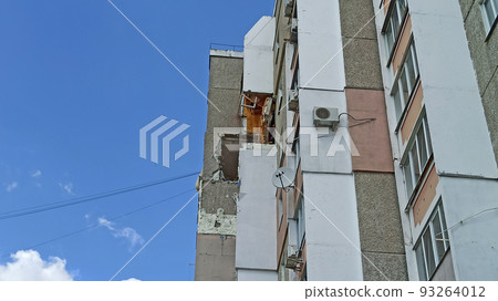 Destruction in wall of multi-storey building after being hit by artillery shell Destruction in wall of multi-storey building after being hit by artillery shell 93264012
