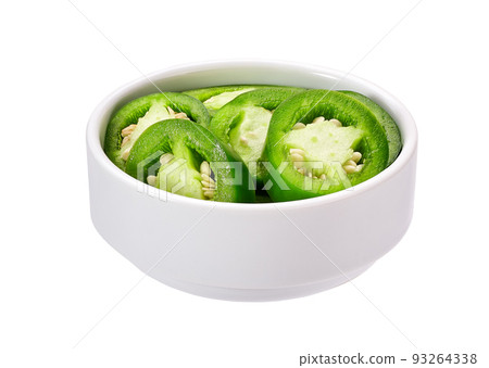 Fresh green cut chili pepper pieces in a white ceramic bowl isolated on white background. Fresh green cut chili pepper pieces in a white ceramic bowl isolated on white background. 93264338