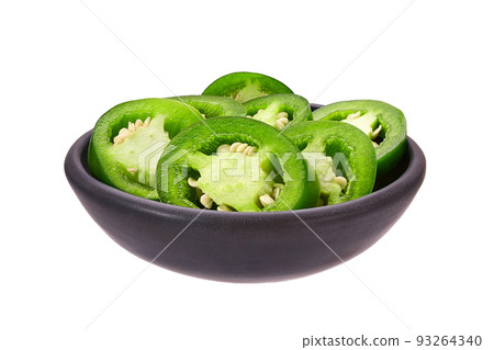 Fresh green cut chili pepper pieces in a black ceramic bowl isolated on white background. 93264340