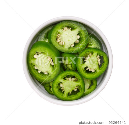 Fresh green cut chili pepper pieces in a white ceramic bowl isolated on white background, top view. Fresh green cut chili pepper pieces in a white ceramic bowl isolated on white background, top view. 93264341