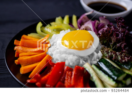Close-up of Korean dish, with variety of appetizers with vegetables and eggs. Diet. pibimpap. Top view. Round plate. Close-up of Korean dish, with variety of appetizers with vegetables and eggs. Diet. pibimpap. Top view. Round plate. 93264484