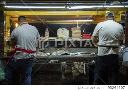 Open air Mexican taqueria Street food Restaurant Where two Mexicans are making tacos and quesadillas Open air Mexican taqueria Street food Restaurant Where two Mexicans are making tacos and quesadillas 93264607