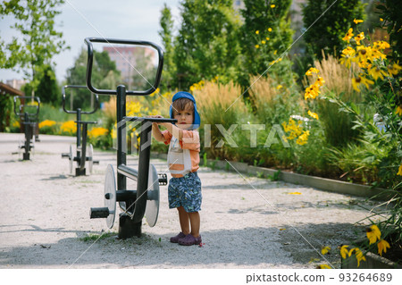 Adorable little 1-2 year old toddler boy having fun on playground in Krakow, Poland Adorable little 1-2 year old toddler boy having fun on playground in Krakow, Poland 93264689