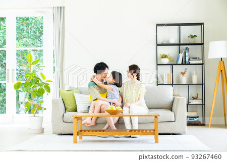 A young family of good friends in the living room 93267460