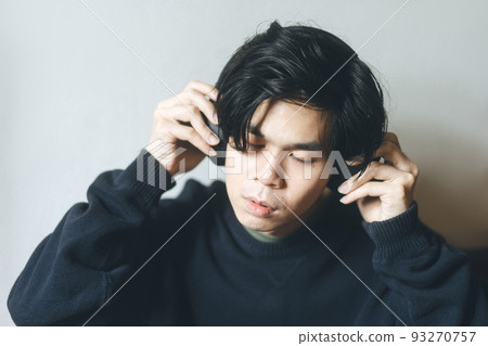 Headshot portrait of young adult asian men with black short hair using headphone listen music Headshot portrait of young adult asian men with black short hair using headphone listen music 93270757