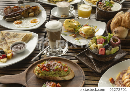 many mixed western breakfast food items on cafe table 93272701