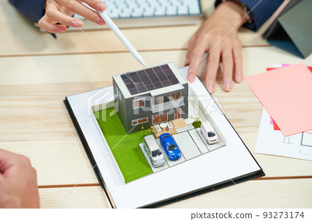 A model of a house with solar panels on the roof 93273174