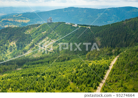 Aerial view of the worlds longest 721 meter suspension footbridge Sky bridge and observation tower the Sky walk in the forest, between mountains, Dolni Morava Ski Resort, Czech Republic. Aerial view of the worlds longest 721 meter suspension footbridge Sky bridge and observation tower the Sky walk in the forest, between mountains, Dolni Morava Ski Resort, Czech Republic. 93274664