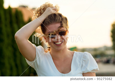 Portrait curly girl outdoors Portrait curly girl outdoors 93275082