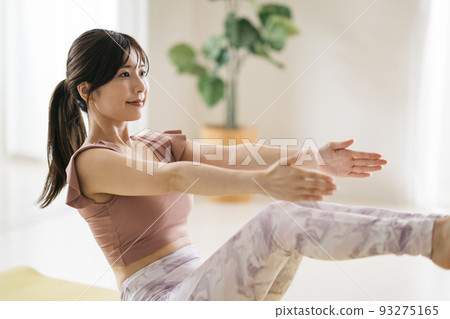 A woman doing Pilates, yoga, and trunk training 93275165