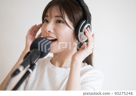 A woman practicing voice training and karaoke 93275248