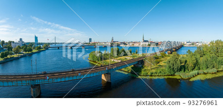 A bridge over river Daugava in Riga with a train passing by. A bridge over river Daugava in Riga with a train passing by. 93276961