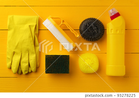 Cleaning tools composition flat lay on yellow wooden background Cleaning tools composition flat lay on yellow wooden background 93278225