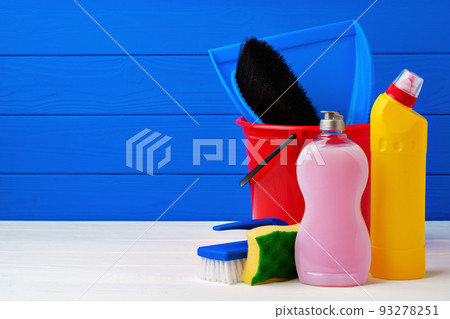 Various cleaning items against blue wooden background 93278251