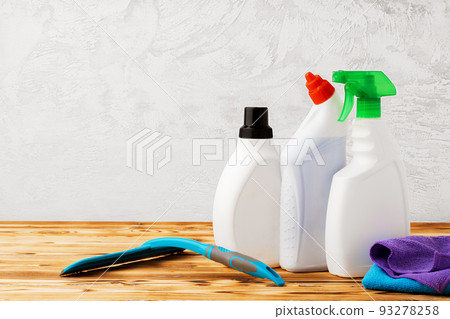 Household cleaning detergents on wooden table against gray background 93278258