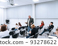 A gray-haired professor of mathematics in college teaches classes in higher mathematics, he walks between the rows of students in the audience and answers their questions 93278622