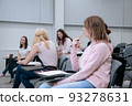 During a college lecture on mathematics, students go about their business, smile and get distracted 93278631