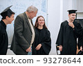 During the presentation of diplomas on the completion of studies at the university, a student girl burst into tears, an elderly professor comforts her 93278644
